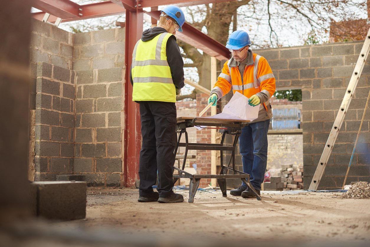 A builder worker with his apprentice